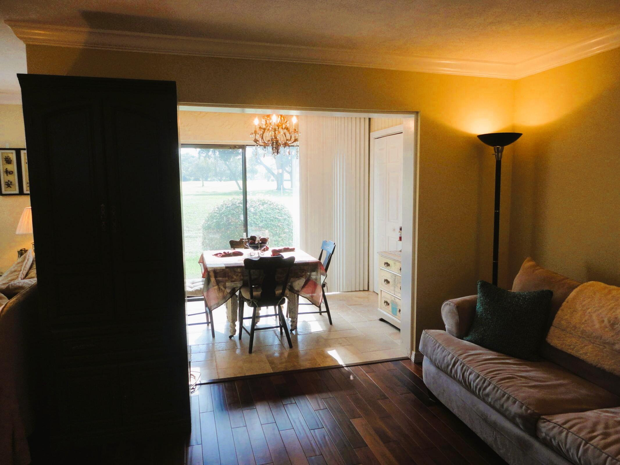 5433 Southeast Miles Grant Road, Unit 104 Stuart, FL 34997 - Photo 14 of 16 a living room with furniture and a large window