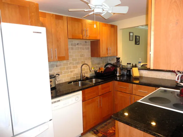 a kitchen with stainless steel appliances a sink and a refrigerator