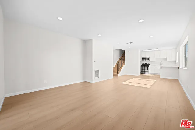 a view of a kitchen with a sink and a window