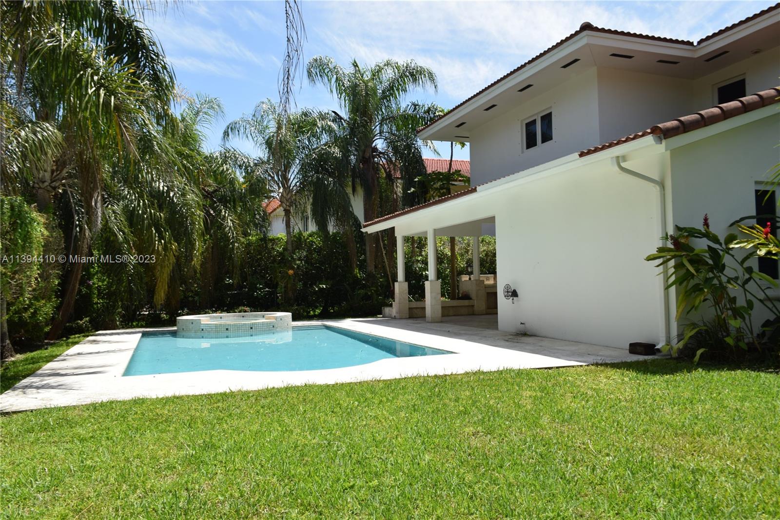 7115 Southwest 69th Court Miami, FL 33143 - Photo 13 of 58 a backyard of a house with table and chairs