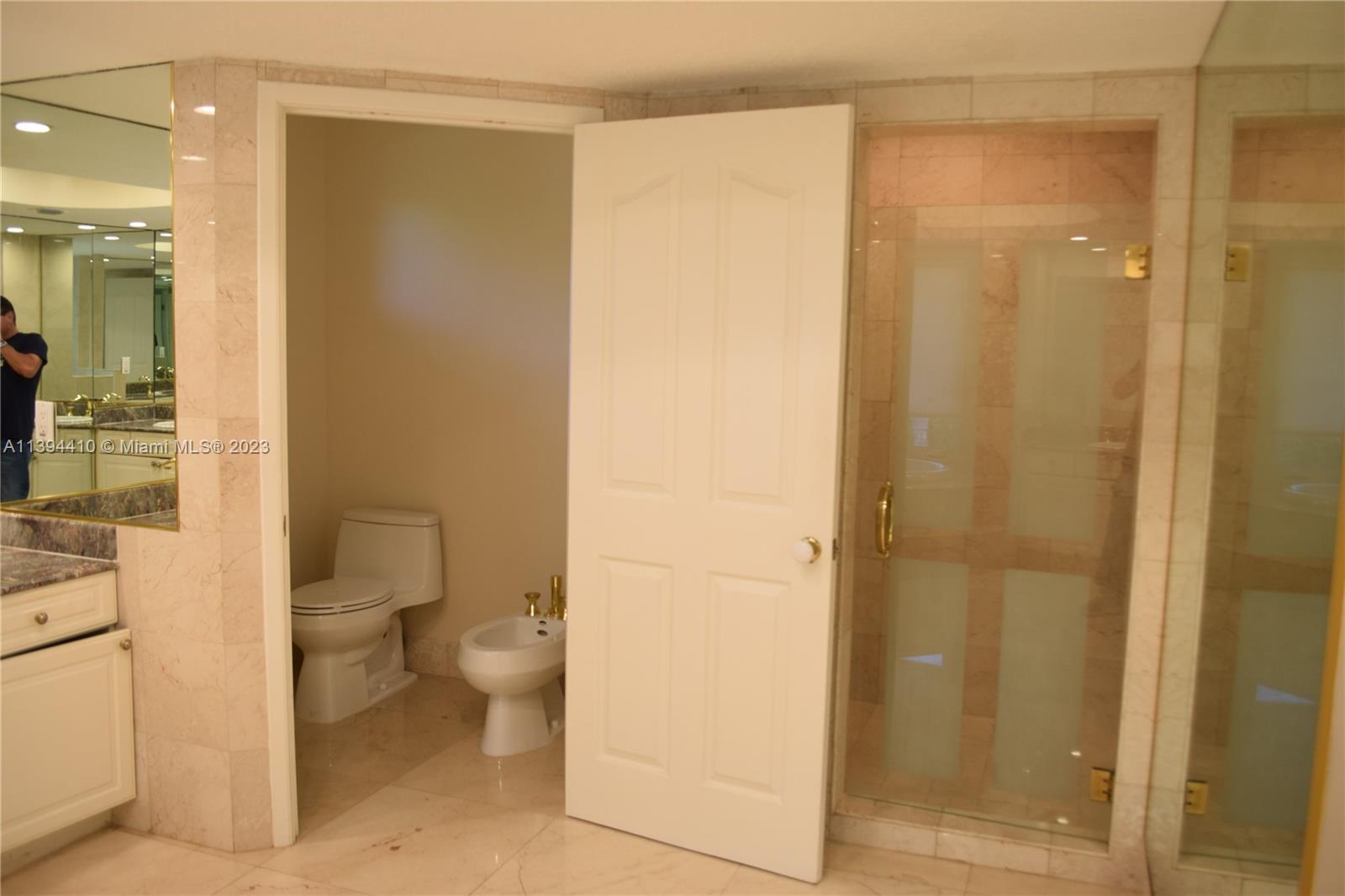 7115 Southwest 69th Court Miami, FL 33143 - Photo 22 of 58 a bathroom with a granite countertop sink toilet and shower