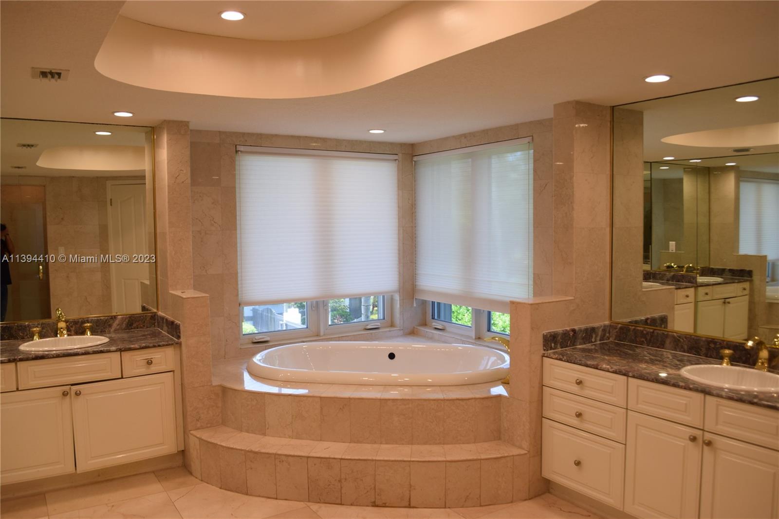 7115 Southwest 69th Court Miami, FL 33143 - Photo 23 of 58 a bathroom with a tub sink and mirror