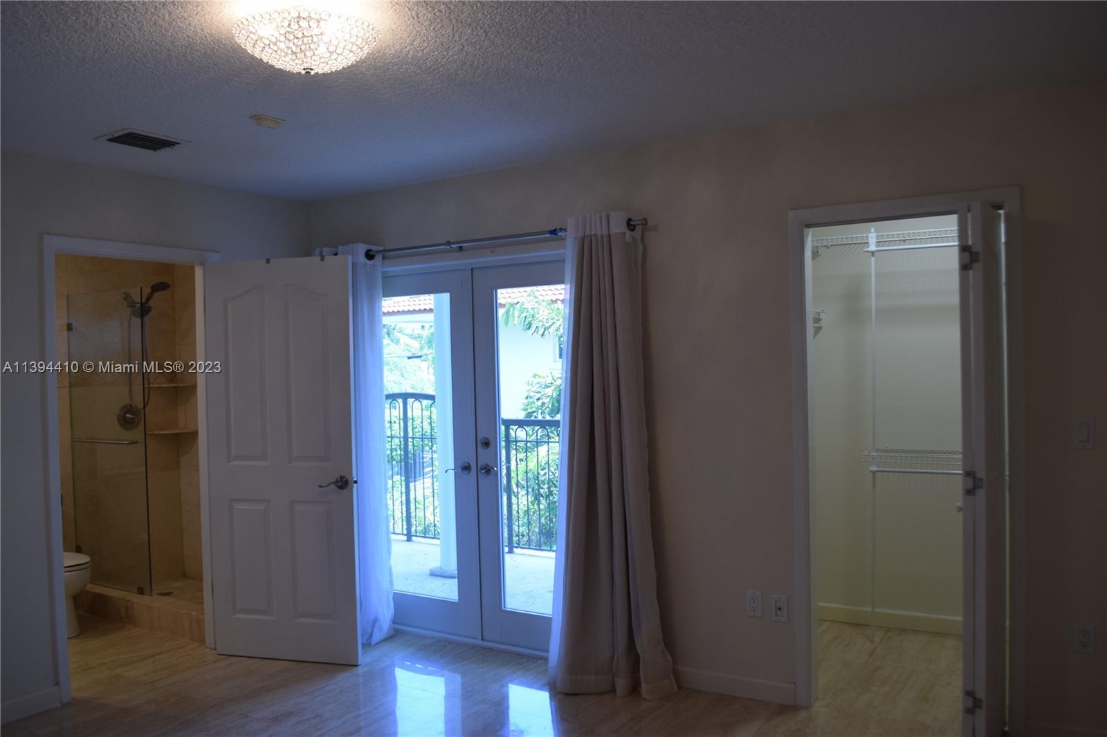 7115 Southwest 69th Court Miami, FL 33143 - Photo 30 of 58 a view of an empty room with wooden floor and a window