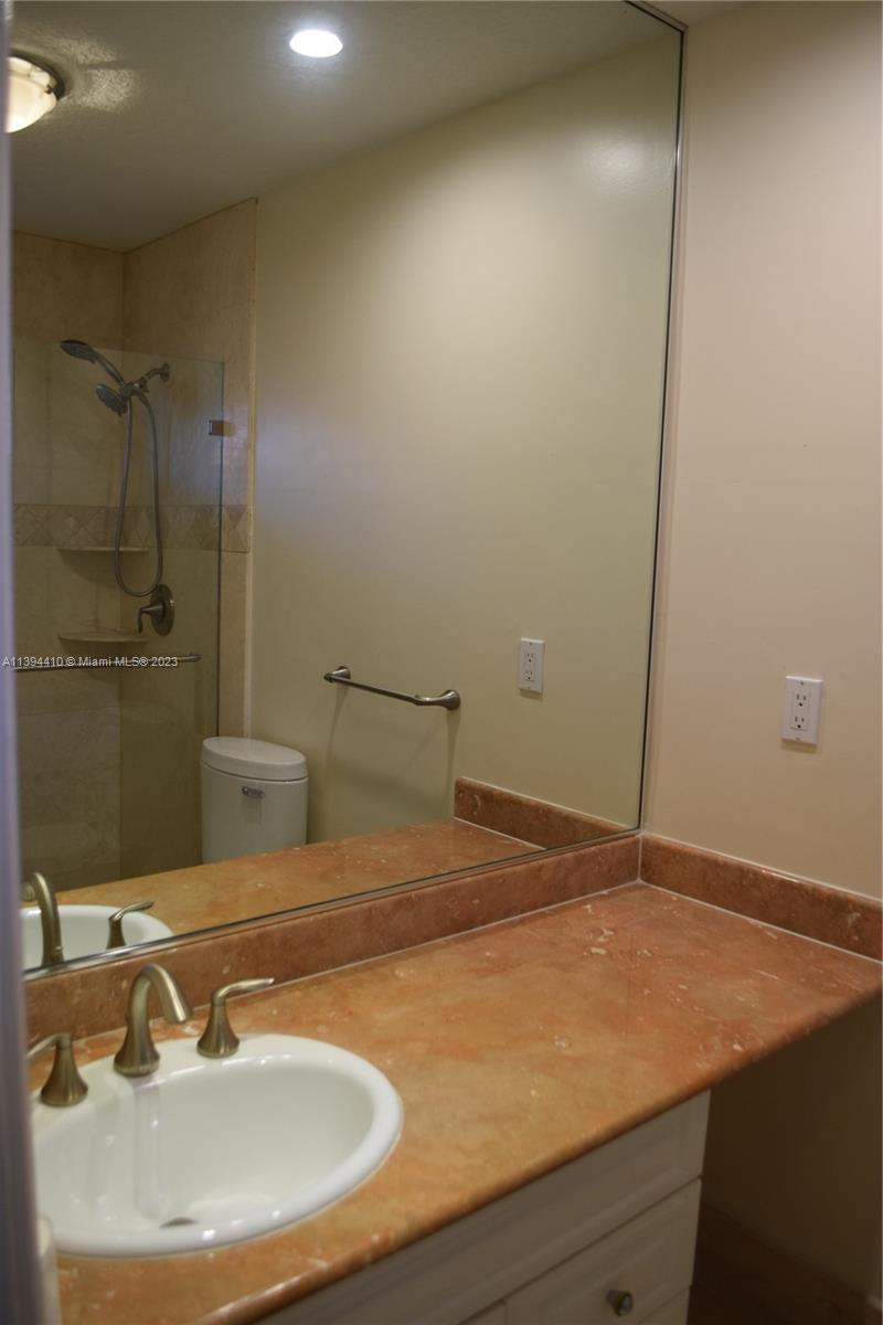 7115 Southwest 69th Court Miami, FL 33143 - Photo 31 of 58 a bathroom with a sink and a mirror