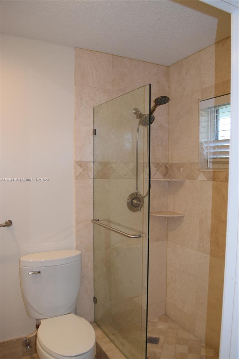 7115 Southwest 69th Court Miami, FL 33143 - Photo 32 of 58 a bathroom with a toilet and a shower