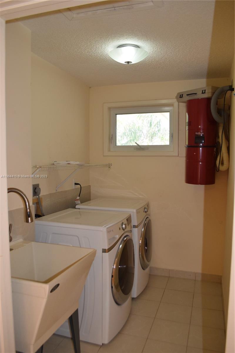 7115 Southwest 69th Court Miami, FL 33143 - Photo 40 of 58 a utility room with dryer and washer