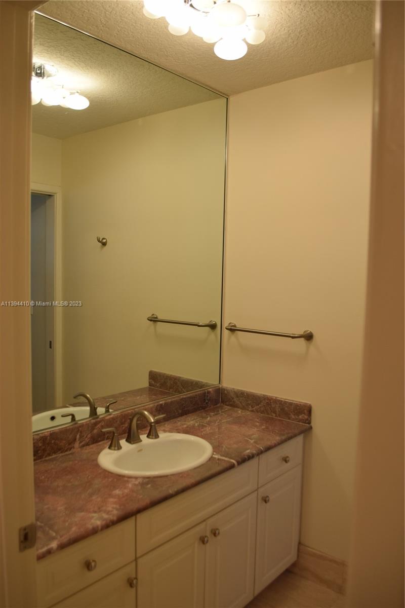 7115 Southwest 69th Court Miami, FL 33143 - Photo 45 of 58 a bathroom with a sink and a mirror