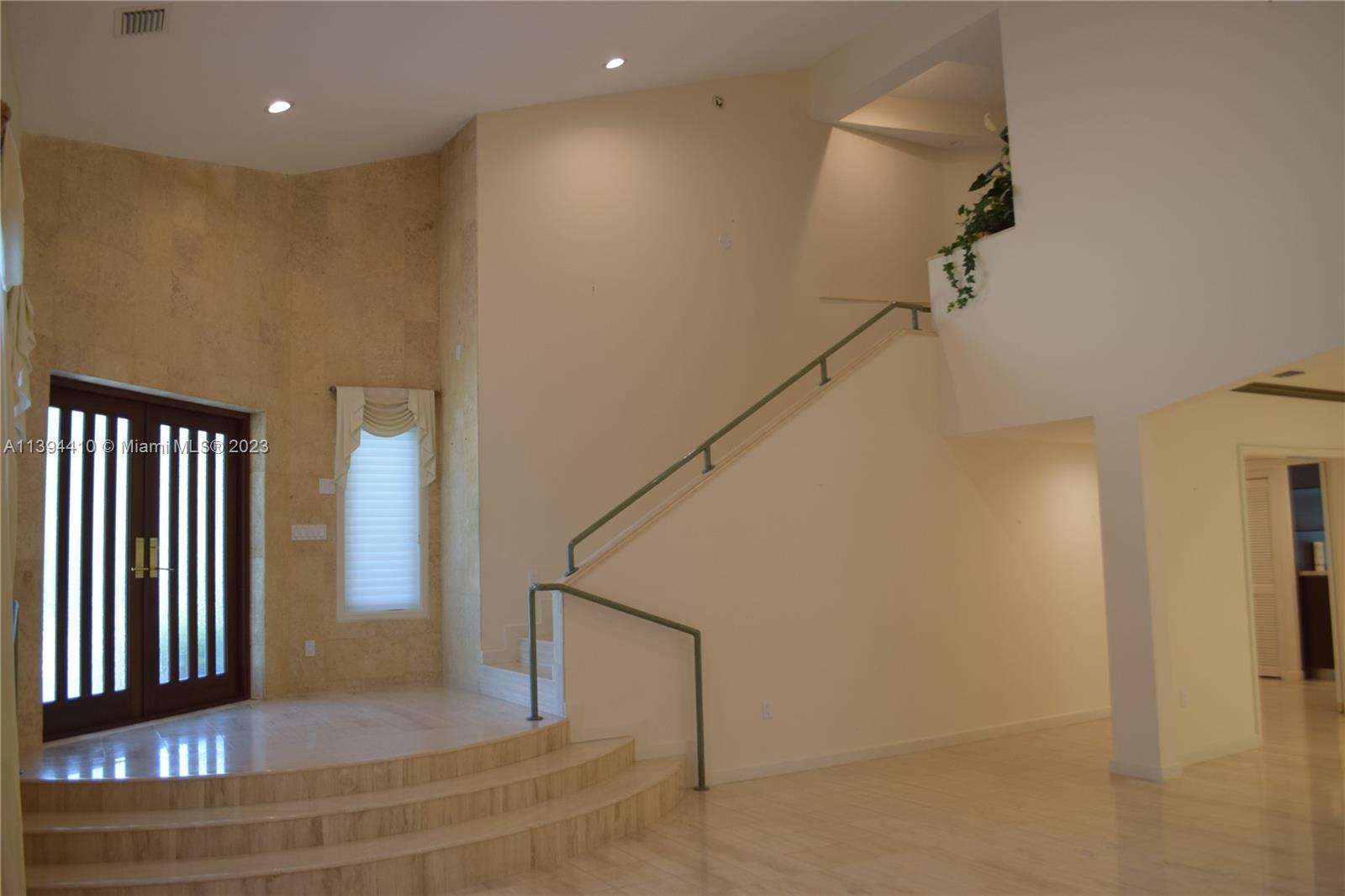 7115 Southwest 69th Court Miami, FL 33143 - Photo 5 of 58 a view of entryway and hall with wooden floor