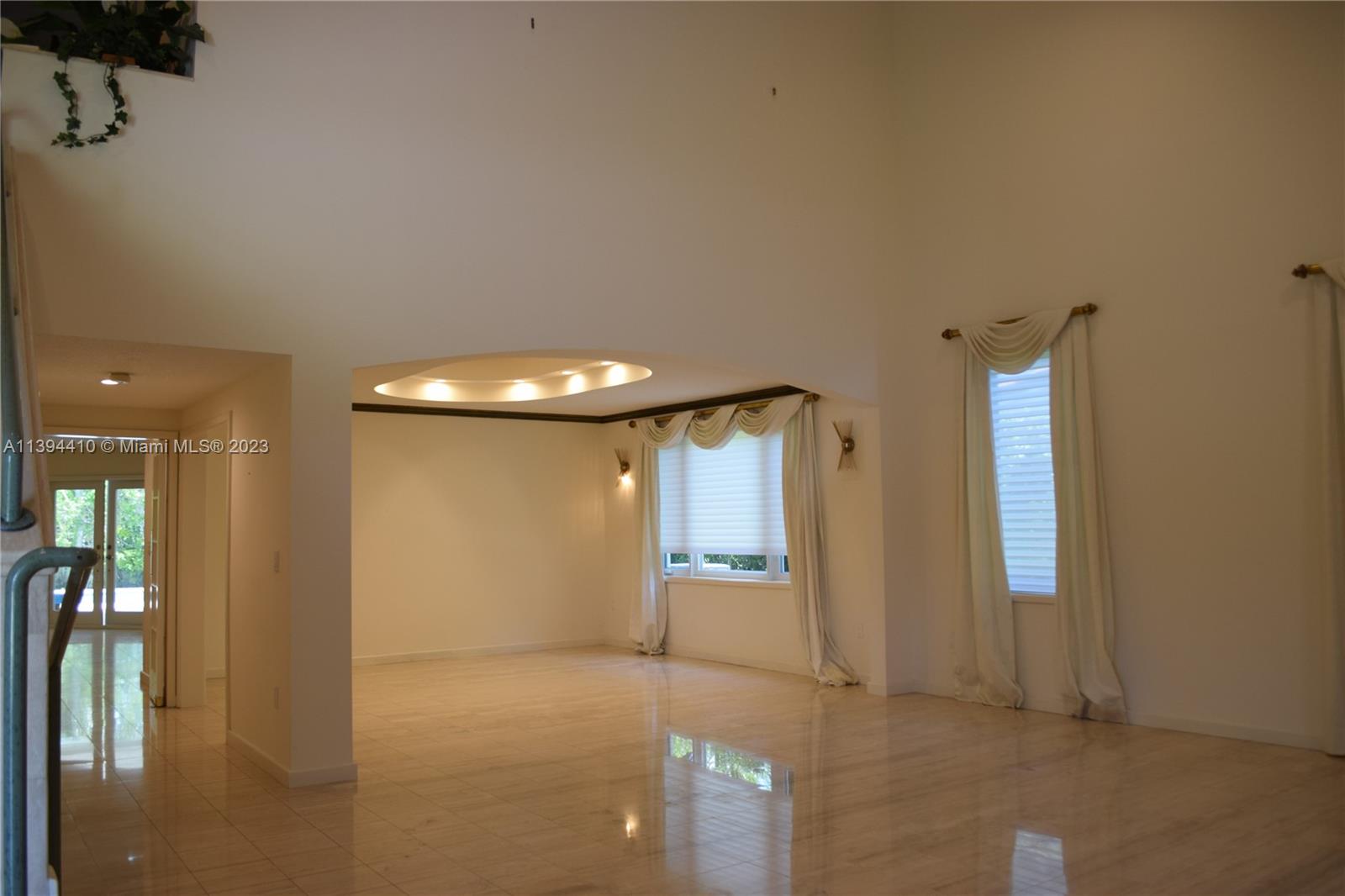 7115 Southwest 69th Court Miami, FL 33143 - Photo 6 of 58 a view of a hallway with wooden floor and a cabinet