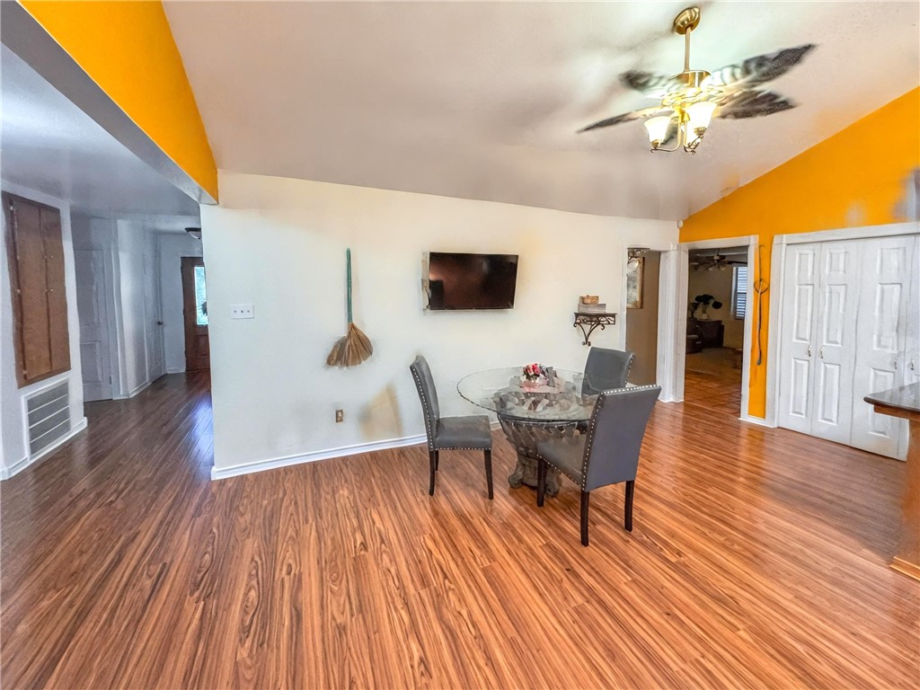 296 County Road 1601 Alice, TX 78332 - Photo 11 of 38 a dining room with wooden floor and a chandelier