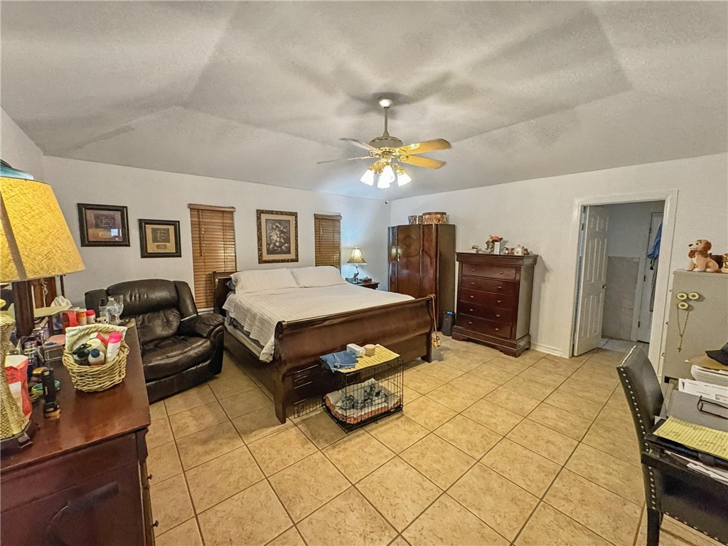296 County Road 1601 Alice, TX 78332 - Photo 22 of 38 a bedroom with a bed and a chandelier
