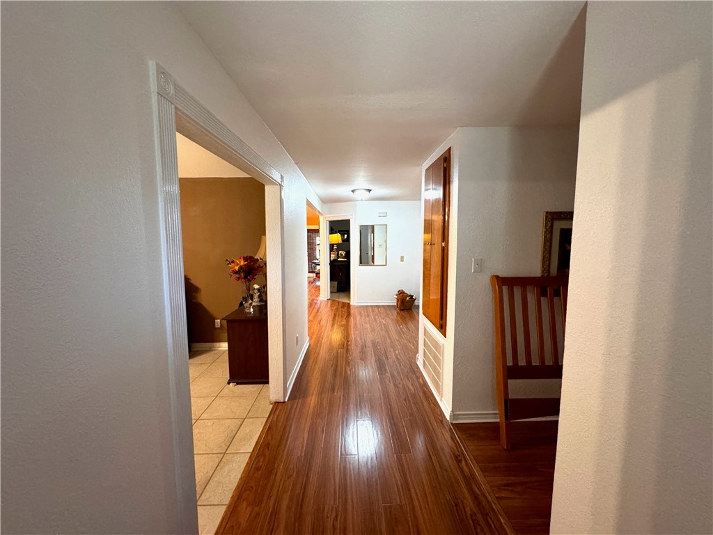 296 County Road 1601 Alice, TX 78332 - Photo 8 of 38 a view of a hallway with wooden floor and staircase