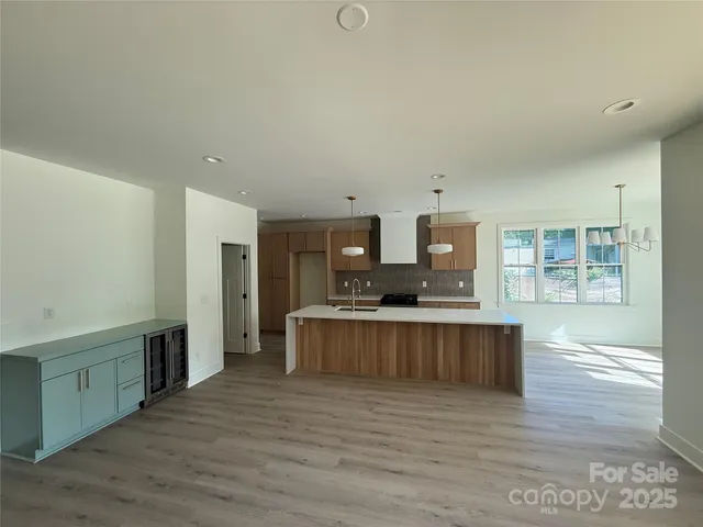 a kitchen with stainless steel appliances a stove top oven and a refrigerator