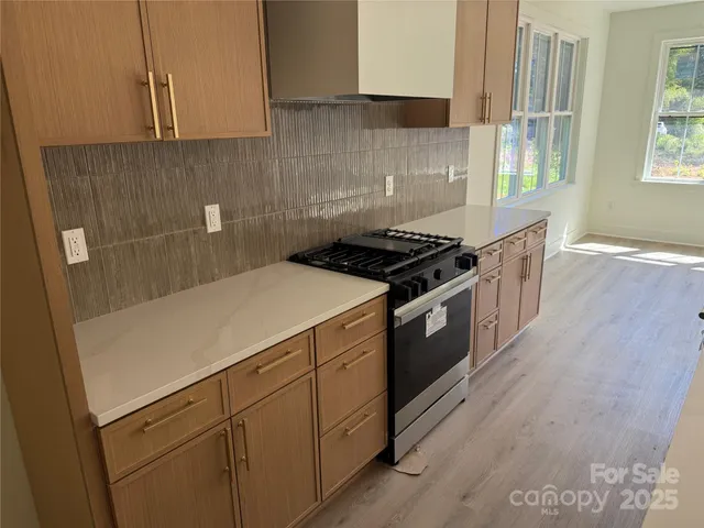 a kitchen with a stove and a white cabinets