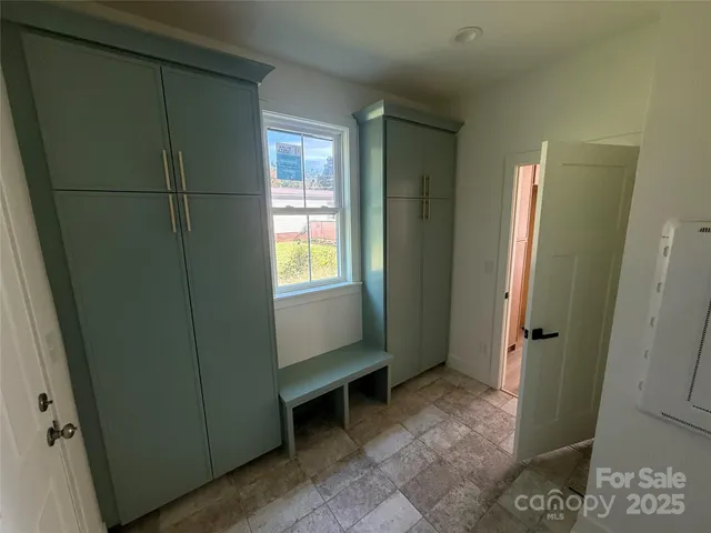 a view of an empty room and a window