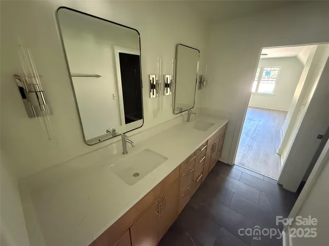 a bathroom with a double vanity sink and a mirror