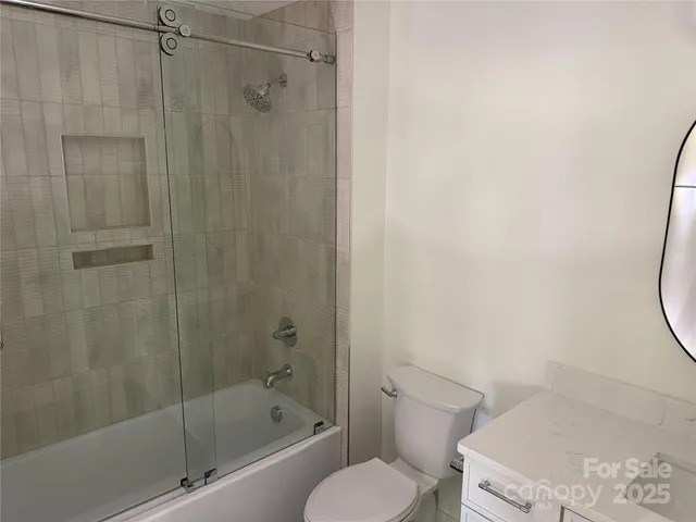 a bathroom with a toilet and shower