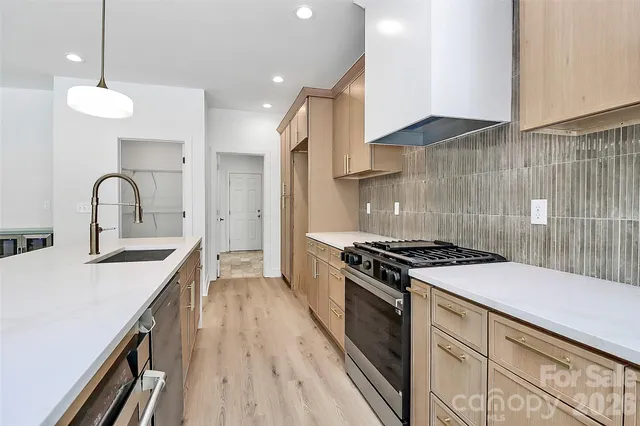 a kitchen with a stove and a sink