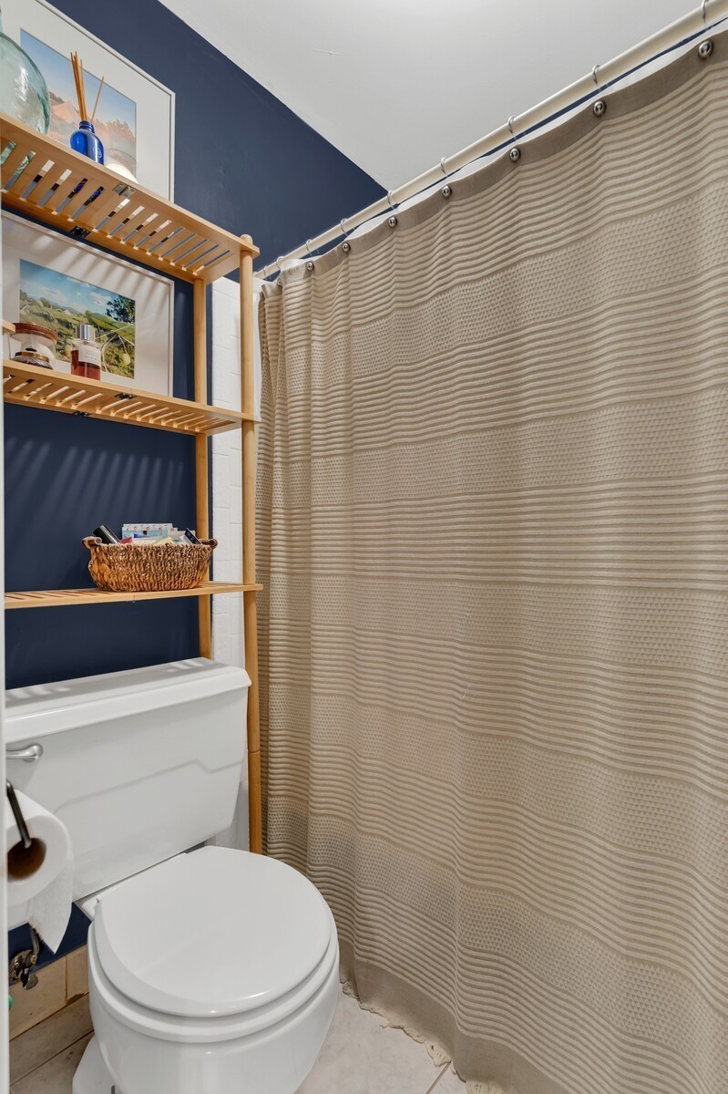 210 Raintree Drive Hermitage, TN 37076 - Photo 17 of 30 a bathroom with a toilet a sink and shower curtain