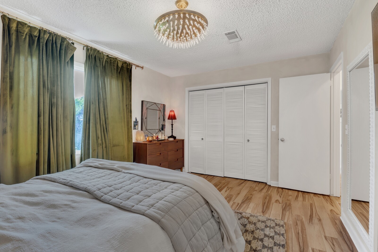210 Raintree Drive Hermitage, TN 37076 - Photo 20 of 30 a bedroom with a large bed and a chandelier