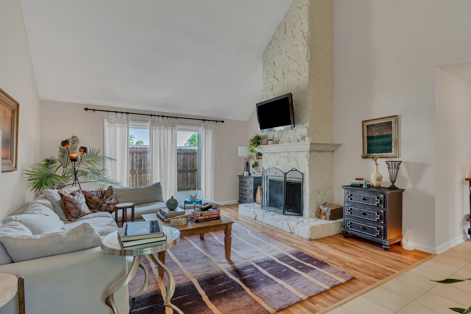 210 Raintree Drive Hermitage, TN 37076 - Photo 4 of 30 a living room with furniture a flat screen tv and a fireplace