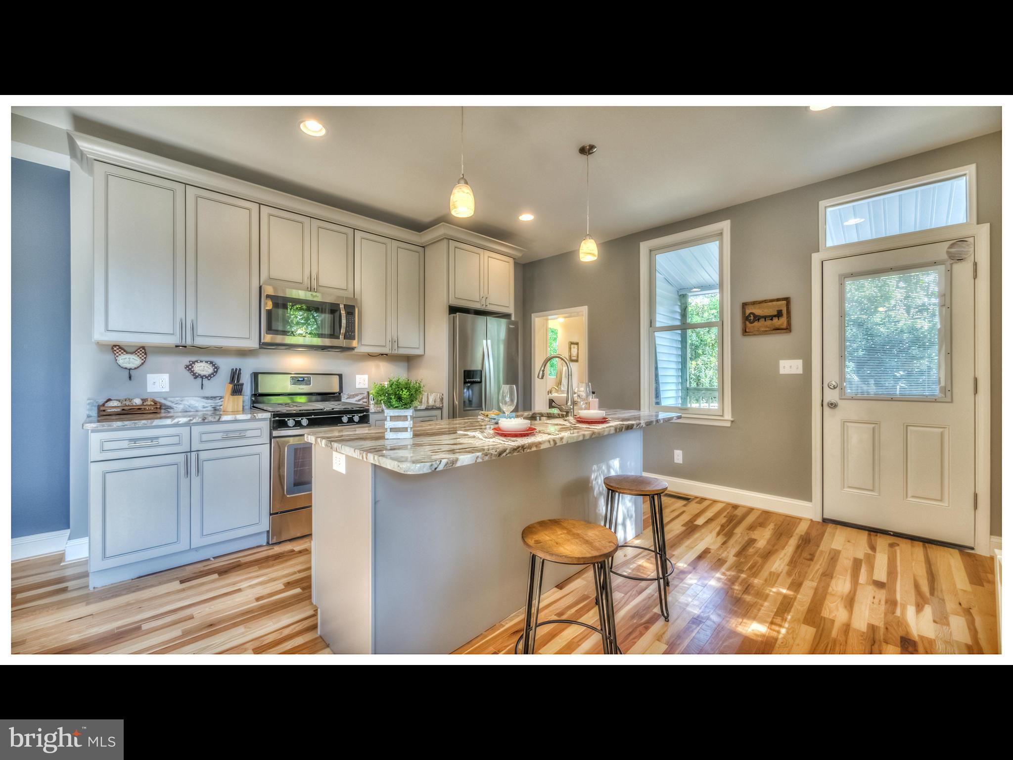 4519 Keswick Road Baltimore, MD 21210 - Photo 9 of 29 a view of kitchen with kitchen island granite countertop a window and a view of living room
