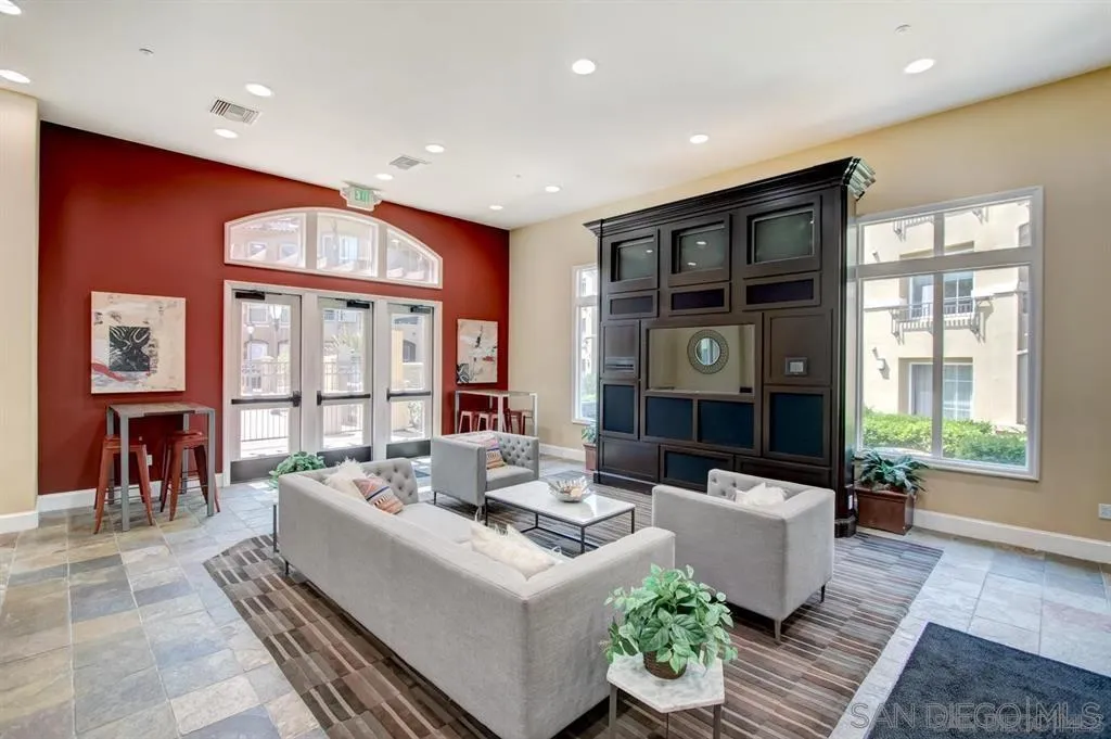 10840 Scripps Ranch Boulevard, Unit 206 San Diego, CA 92131 - Photo 8 of 13 a living room with fireplace furniture and a large window