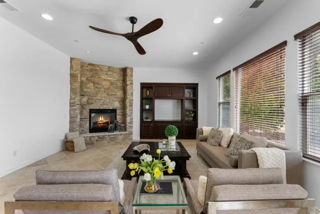 a kitchen with stainless steel appliances kitchen island granite countertop a table chairs sink and cabinets