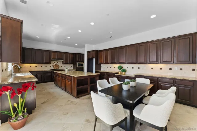 a kitchen with granite countertop a sink stove and cabinets