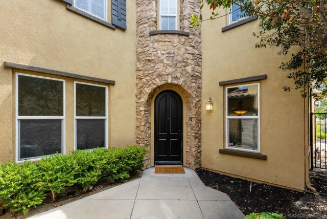 a front view of a house with a garden