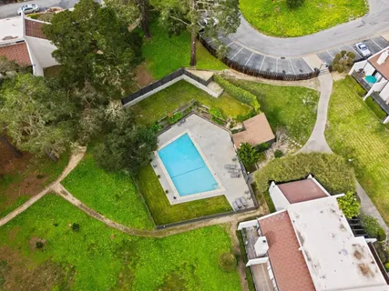 an aerial view of a house with outdoor space pool patio and lake view