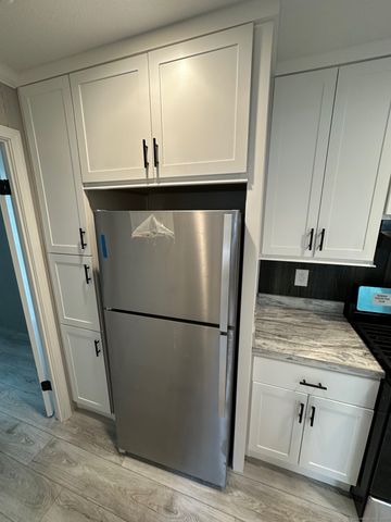 a refrigerator freezer sitting inside of a kitchen