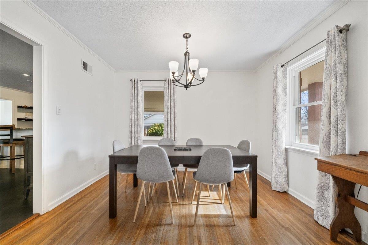 436 Cardinal Drive Collierville, TN 38017 - Photo 5 of 32 a view of a dining room with furniture a chandelier and wooden floor