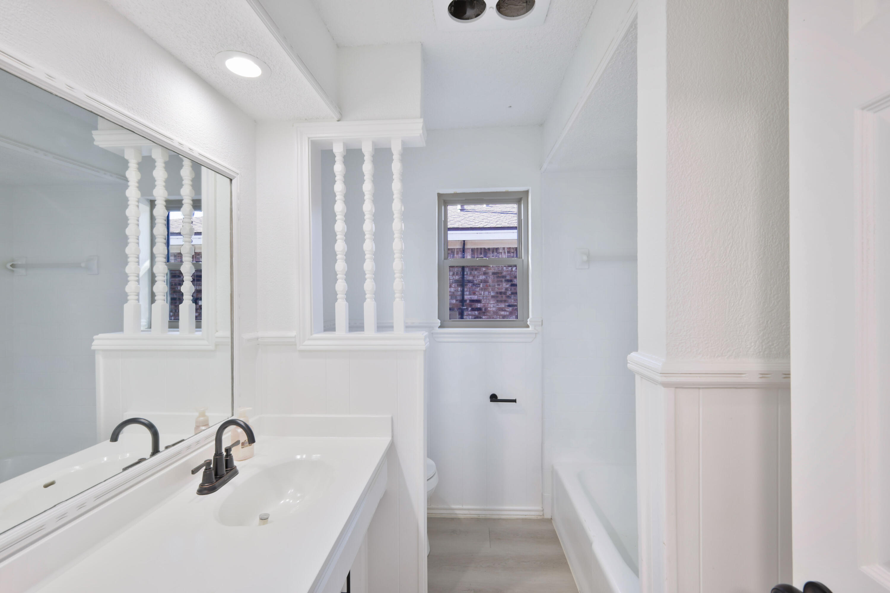 5104 73rd Street Lubbock, TX 79424 - Photo 12 of 20 a bathroom with a sink and mirror