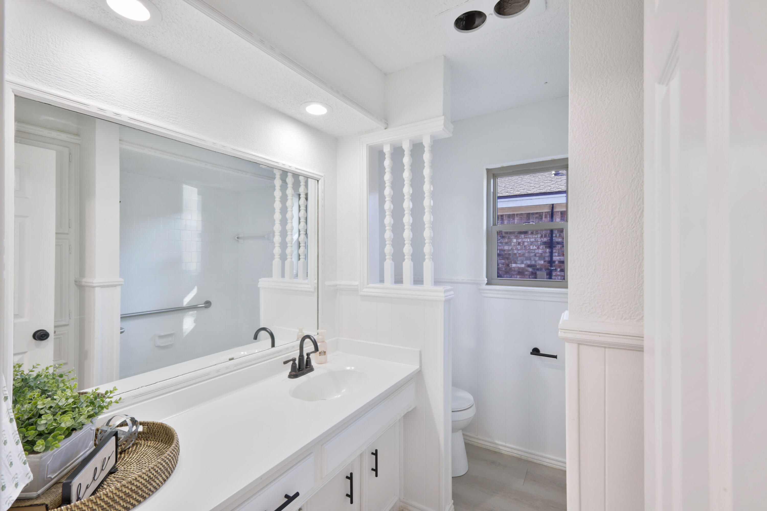 5104 73rd Street Lubbock, TX 79424 - Photo 13 of 20 a bathroom with a granite countertop sink mirror and a bathtub