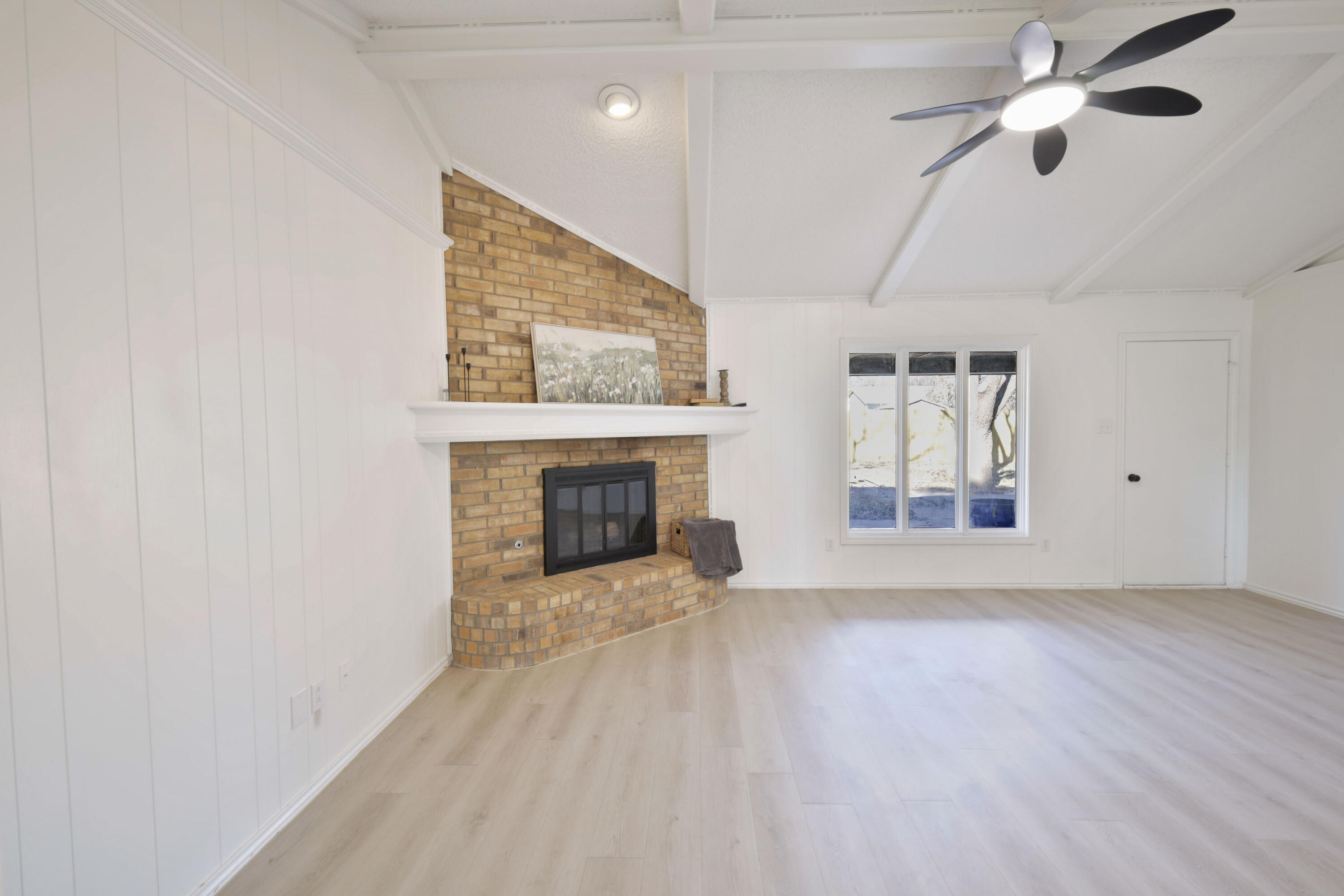 5104 73rd Street Lubbock, TX 79424 - Photo 3 of 20 a view of a livingroom with a fireplace a ceiling fan and closet