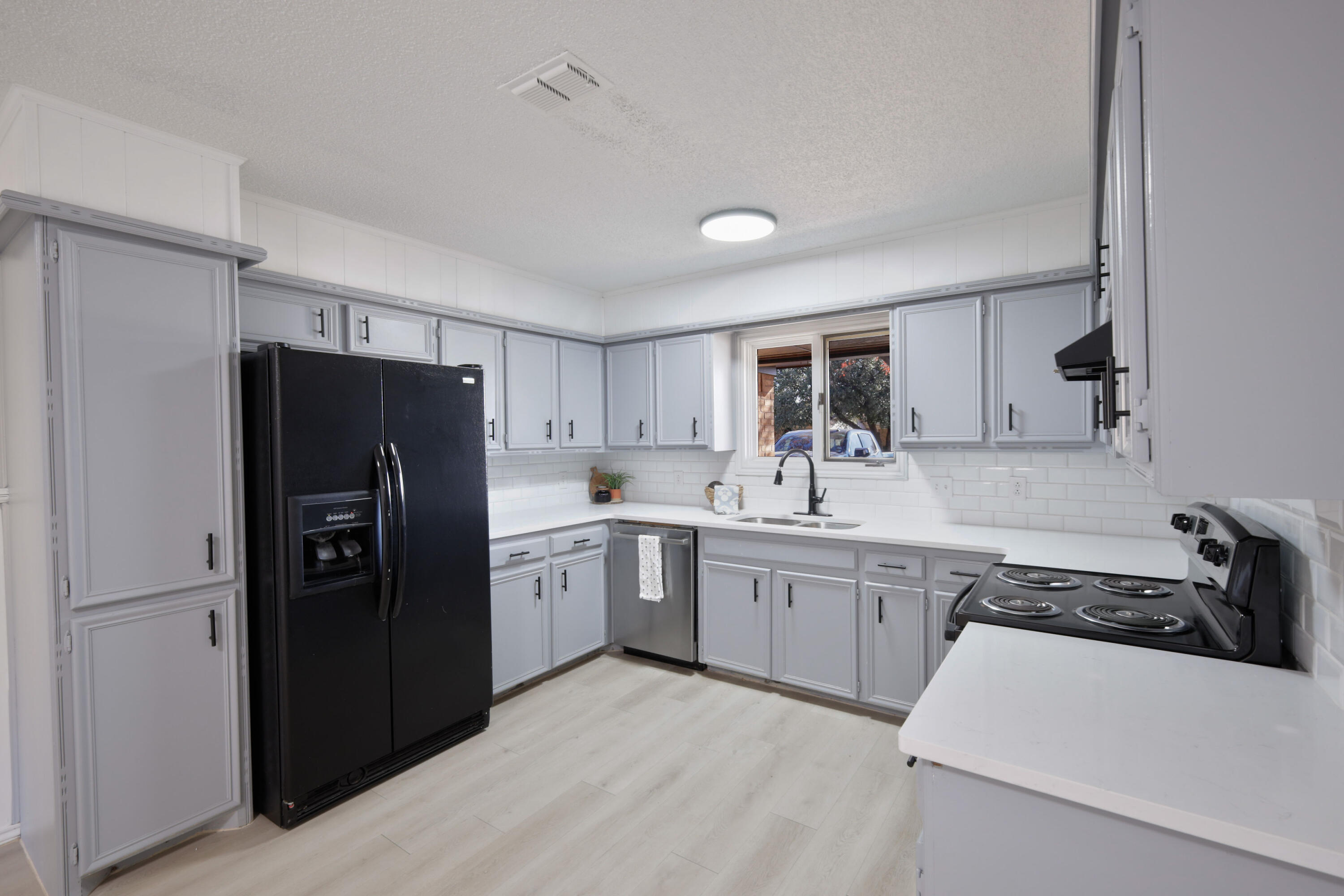 5104 73rd Street Lubbock, TX 79424 - Photo 4 of 20 a kitchen with stainless steel appliances a refrigerator sink and cabinets