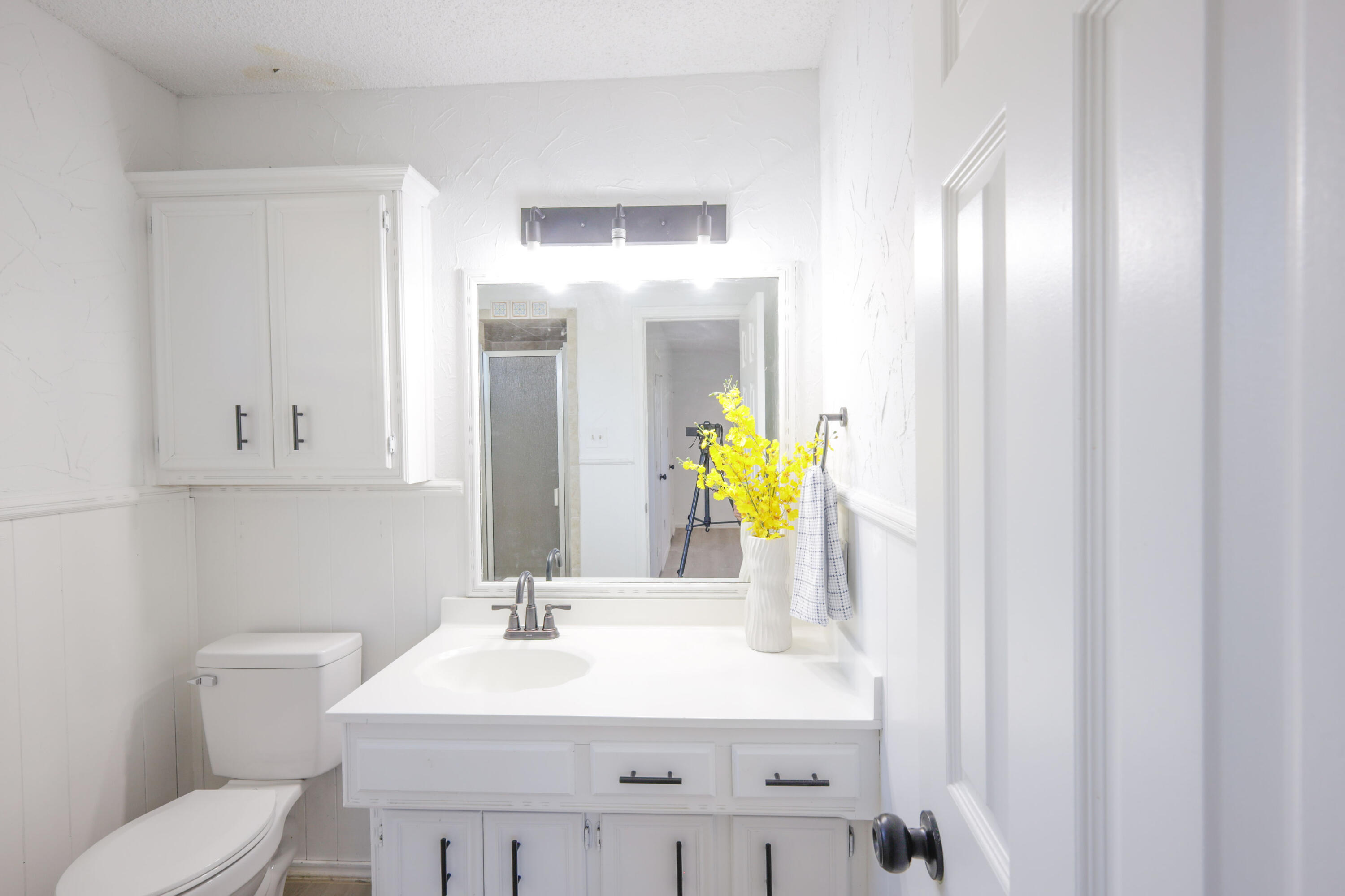 5104 73rd Street Lubbock, TX 79424 - Photo 9 of 20 a bathroom with a sink and a mirror