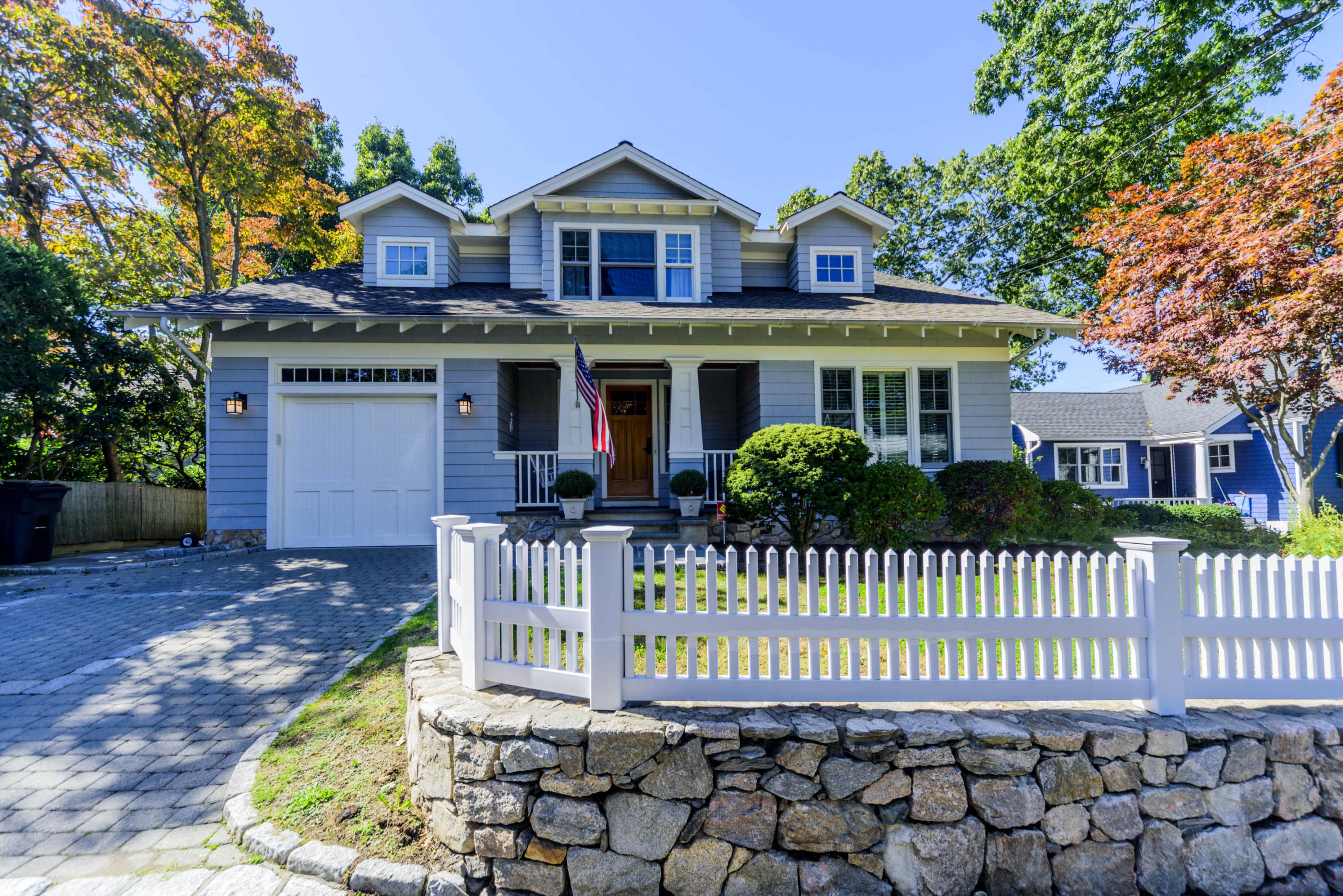 a front view of a house with a garden