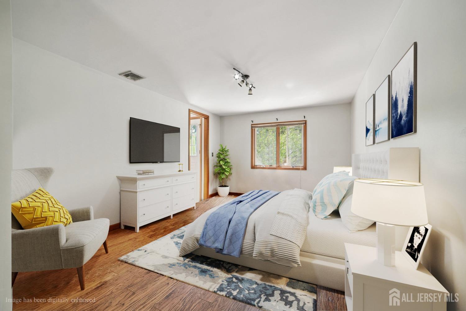 442 Garretson Road Bridgewater, NJ 08807 - Photo 11 of 29 a bedroom with a bed and a flat screen tv