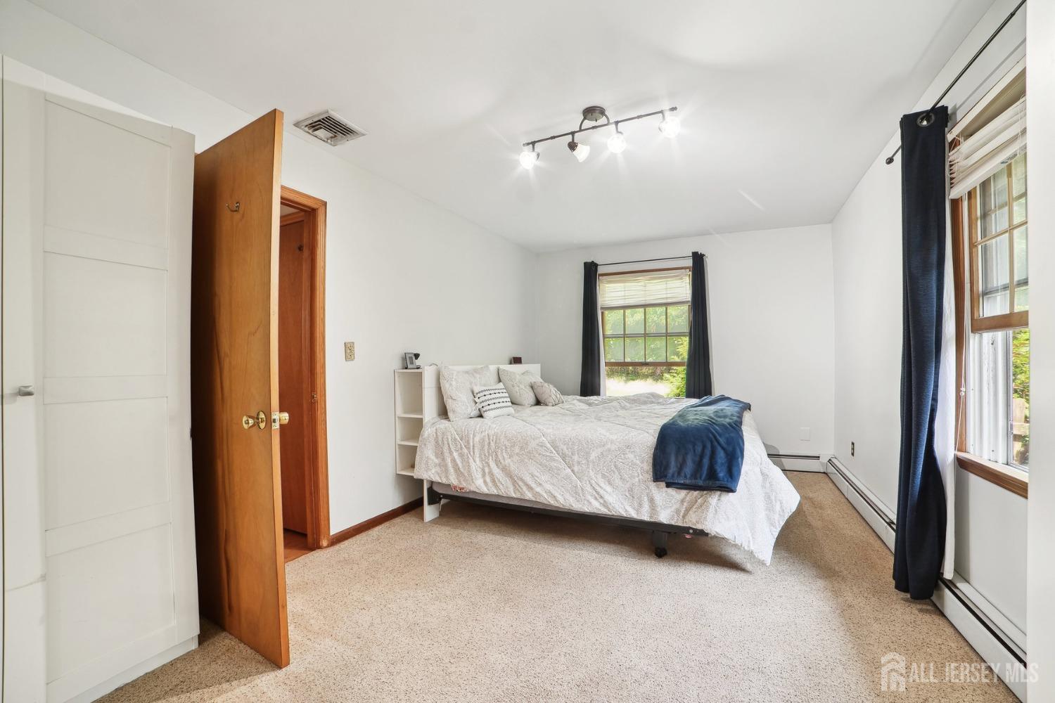 442 Garretson Road Bridgewater, NJ 08807 - Photo 16 of 29 a spacious bedroom with a bed and a window