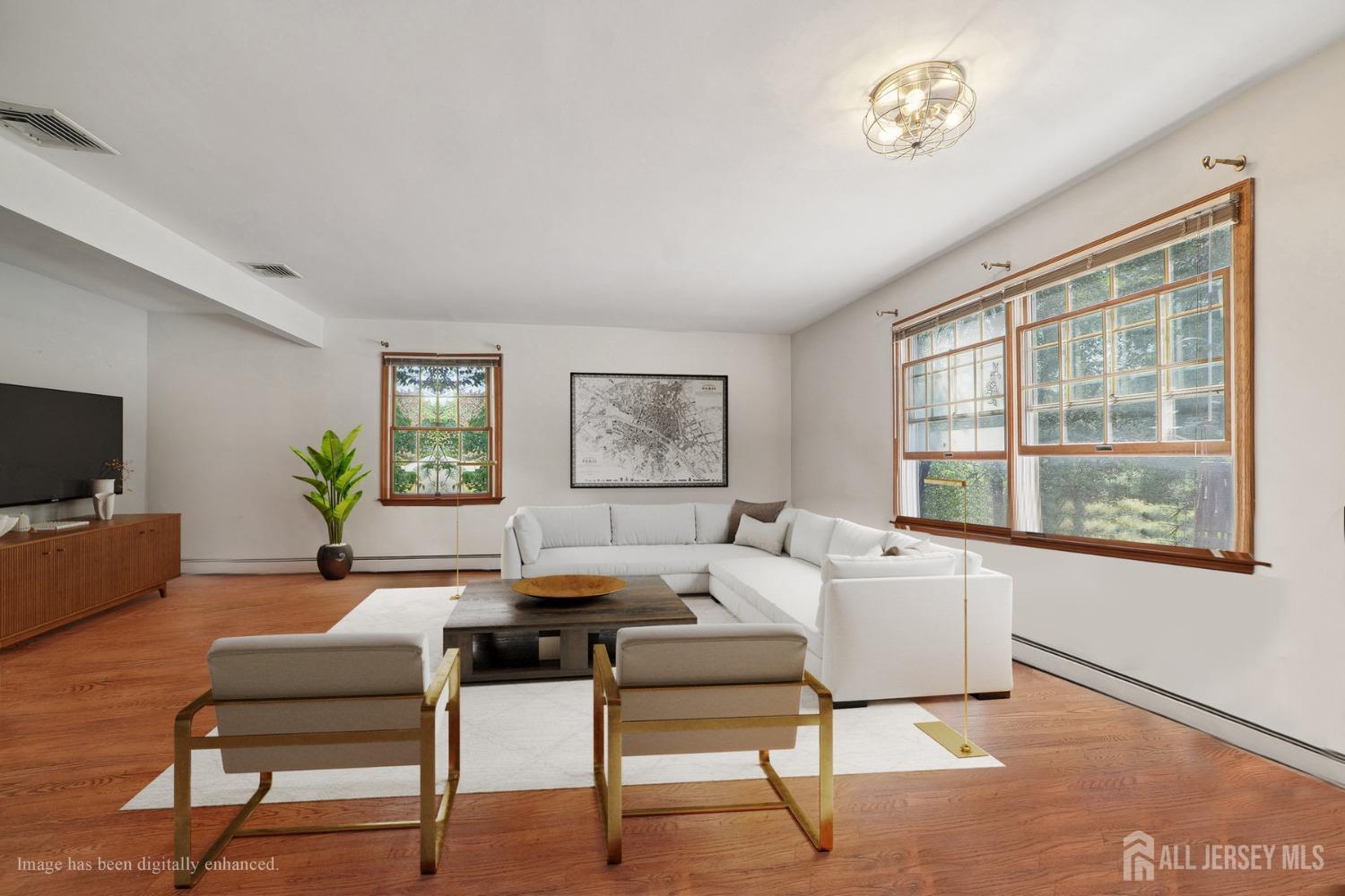 442 Garretson Road Bridgewater, NJ 08807 - Photo 4 of 29 a living room with furniture a flat screen tv and a window