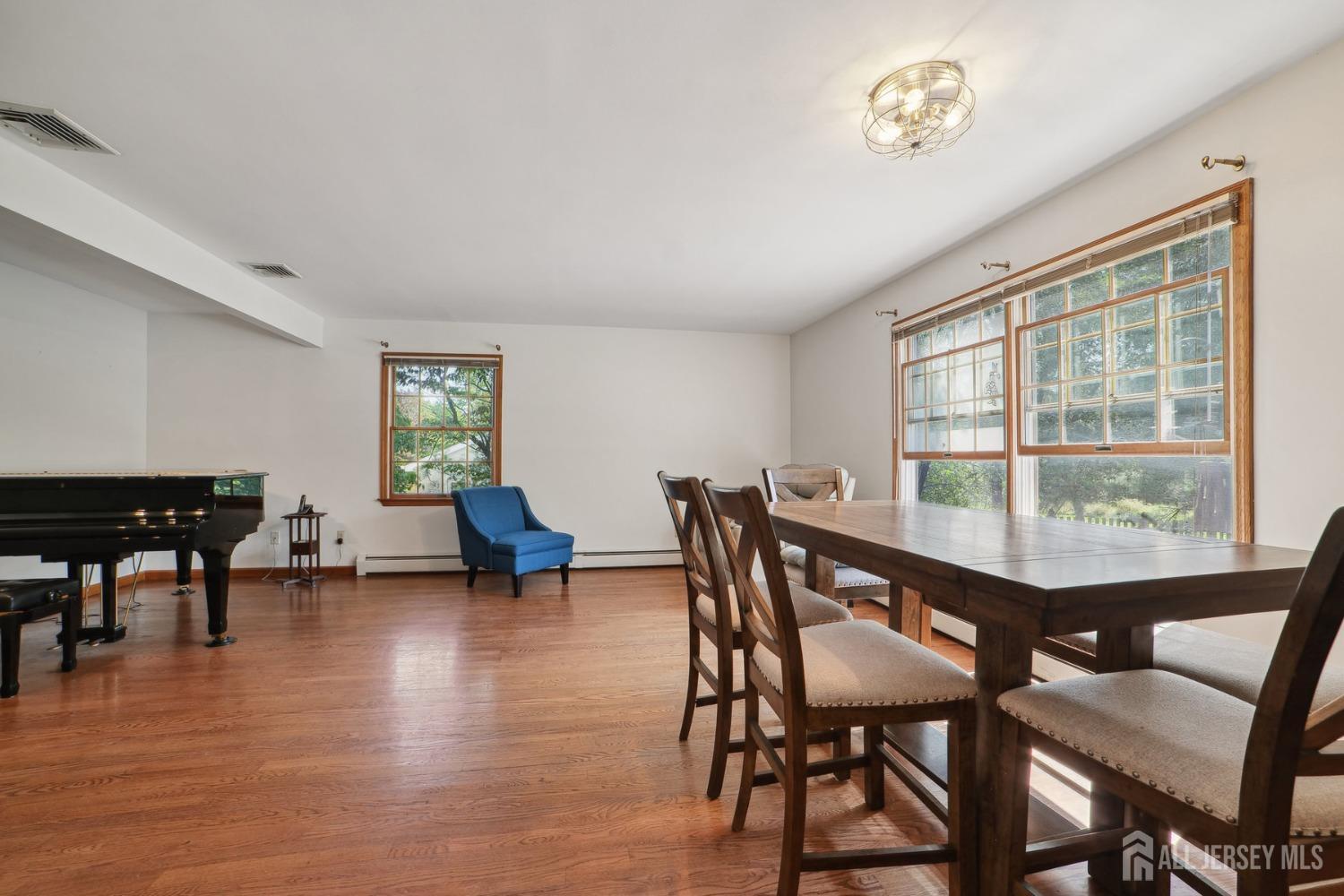 442 Garretson Road Bridgewater, NJ 08807 - Photo 5 of 29 a view of a dining room with furniture and a wooden floor