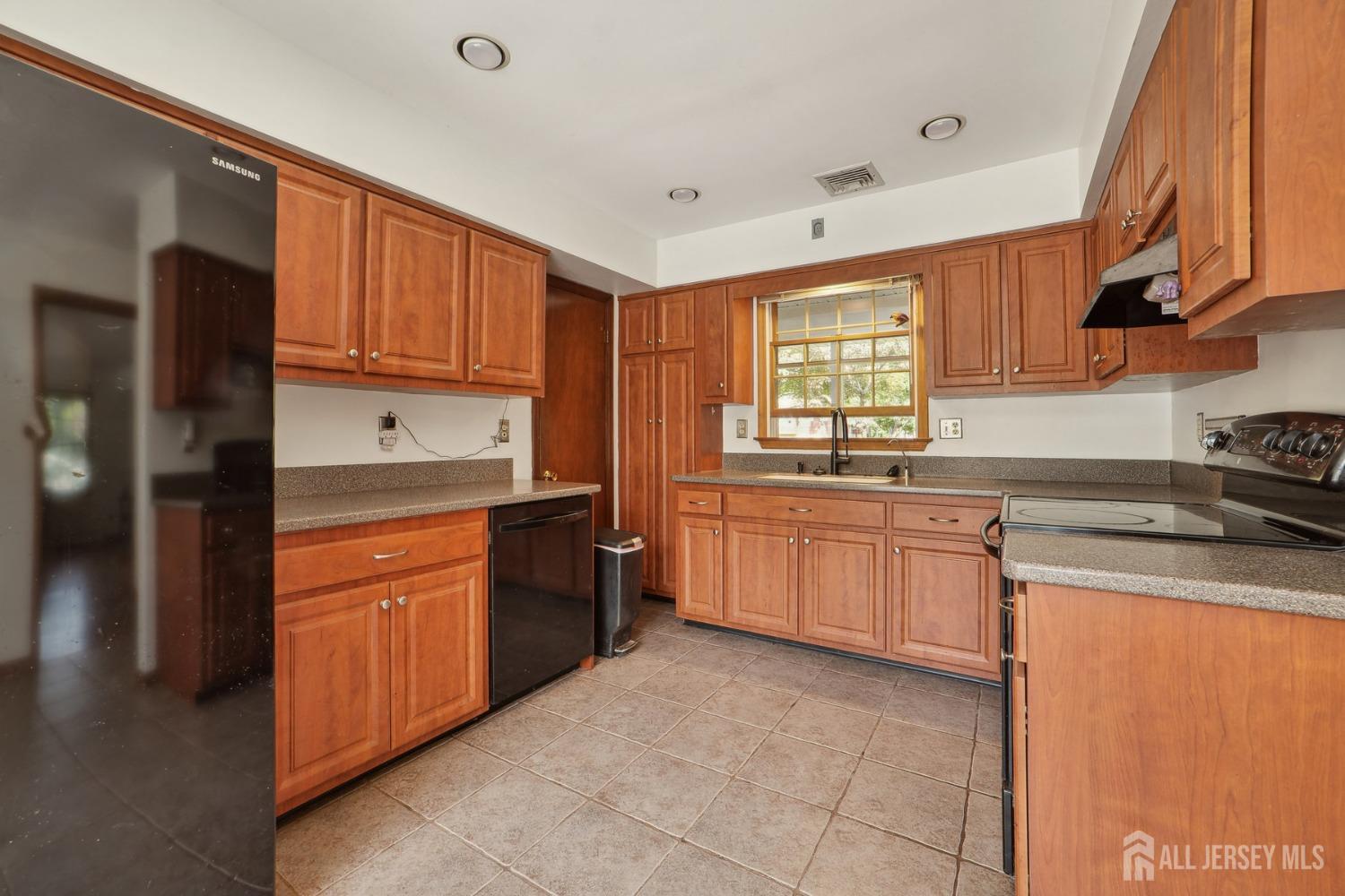 442 Garretson Road Bridgewater, NJ 08807 - Photo 7 of 29 a kitchen with stainless steel appliances granite countertop a sink stove and refrigerator