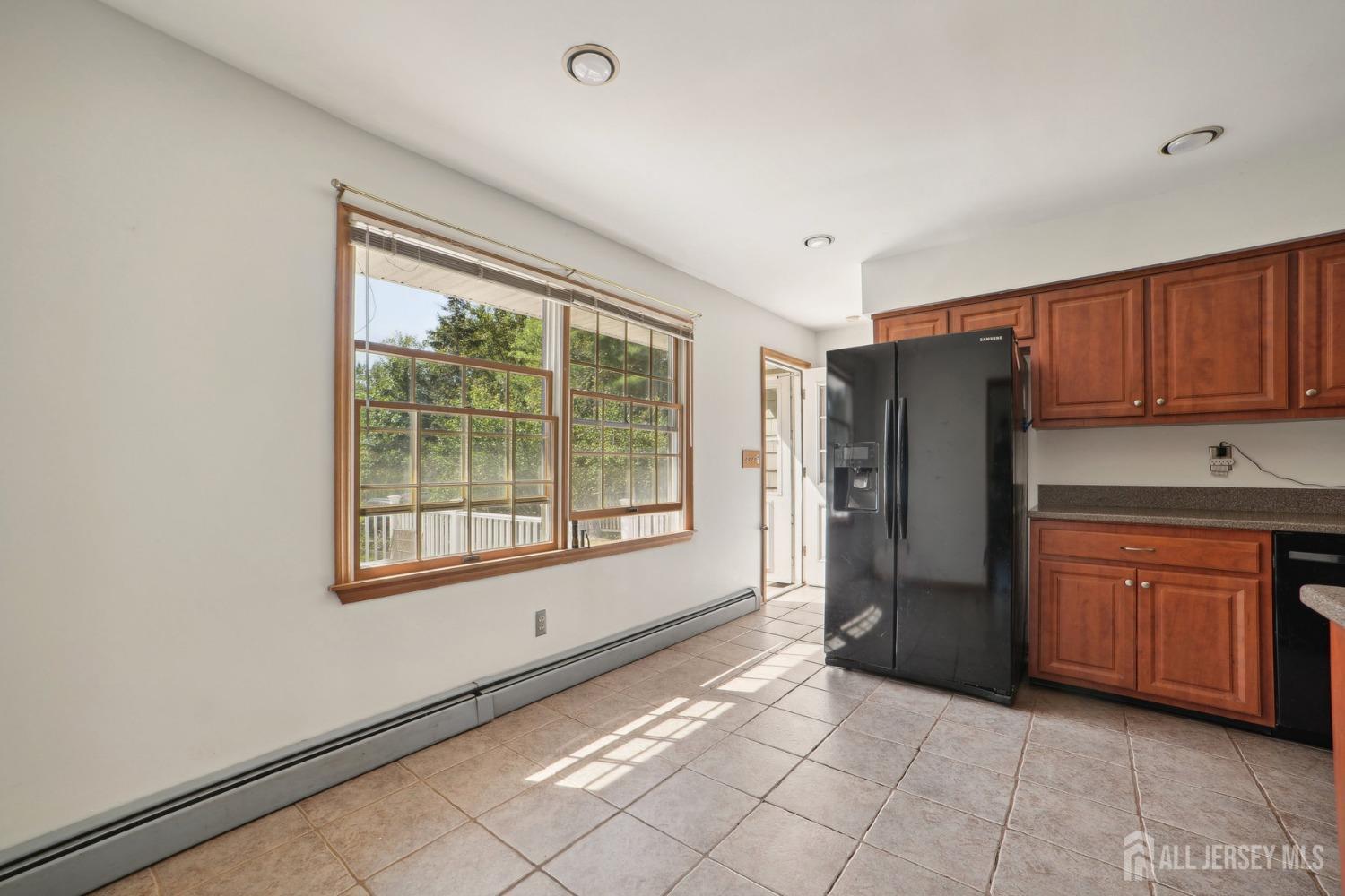 442 Garretson Road Bridgewater, NJ 08807 - Photo 9 of 29 a view of a kitchen with a refrigerator cabinet and a window