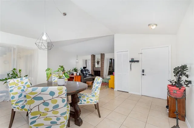 a view of a dining room with furniture and a chandelier
