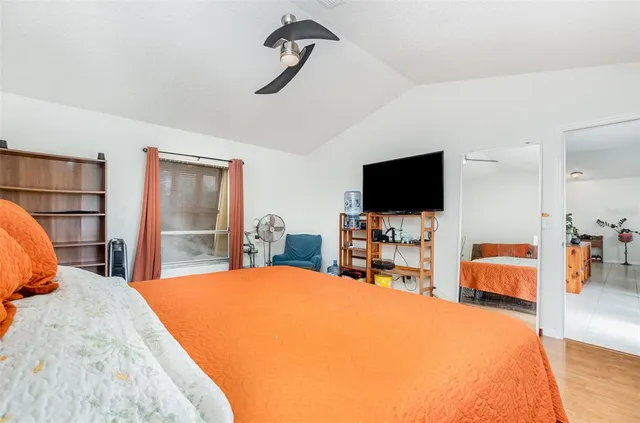 a bedroom with a bed and a flat screen tv