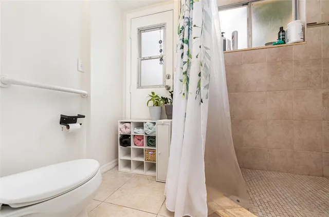 a bathroom with a toilet and shower