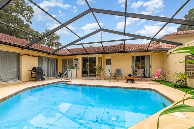a view of a patio with a table and chairs under an umbrella