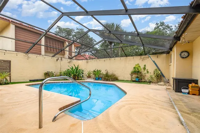 a view of a swimming pool with a patio and a tub